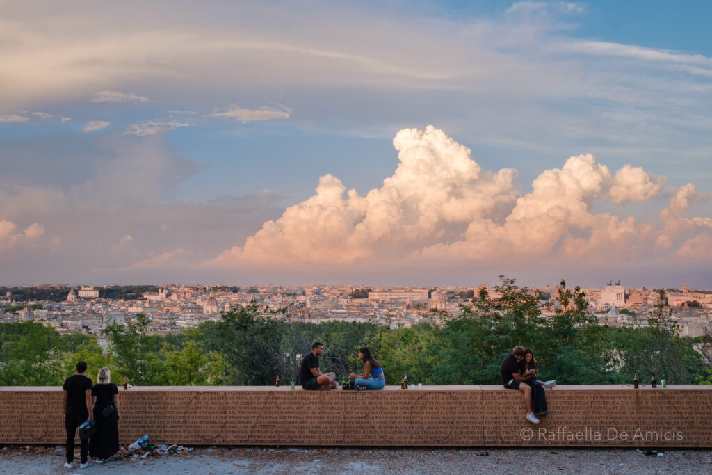 learn to travel independently with confidence; friends and lovers watch a dramatic sunset over Rome, Italy from Janiculum Hill