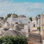 Whitewashed trulli and their conical roofs in Puglia, Italy. A must for any Puglia Itinerary.