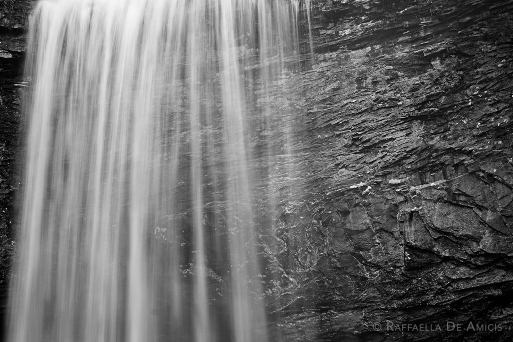 Close up black and white image of a waterfall
