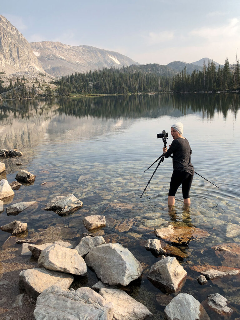 Travel and landscape photographer at work on a Wyoming lake
