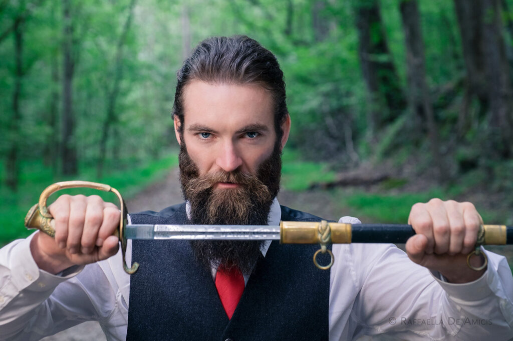 cinematic portrait of Sam Hargrave (actor, stunt coordinator, director) in formal dress with sword, created using off-camera flash