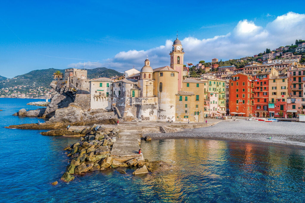 Camogli, Italy viewed from the sea with colorful buildings and blue sky