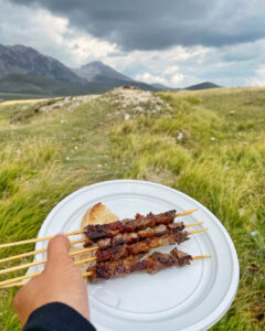 arrosticini meat skewers with Gran Sasso mountains in the background