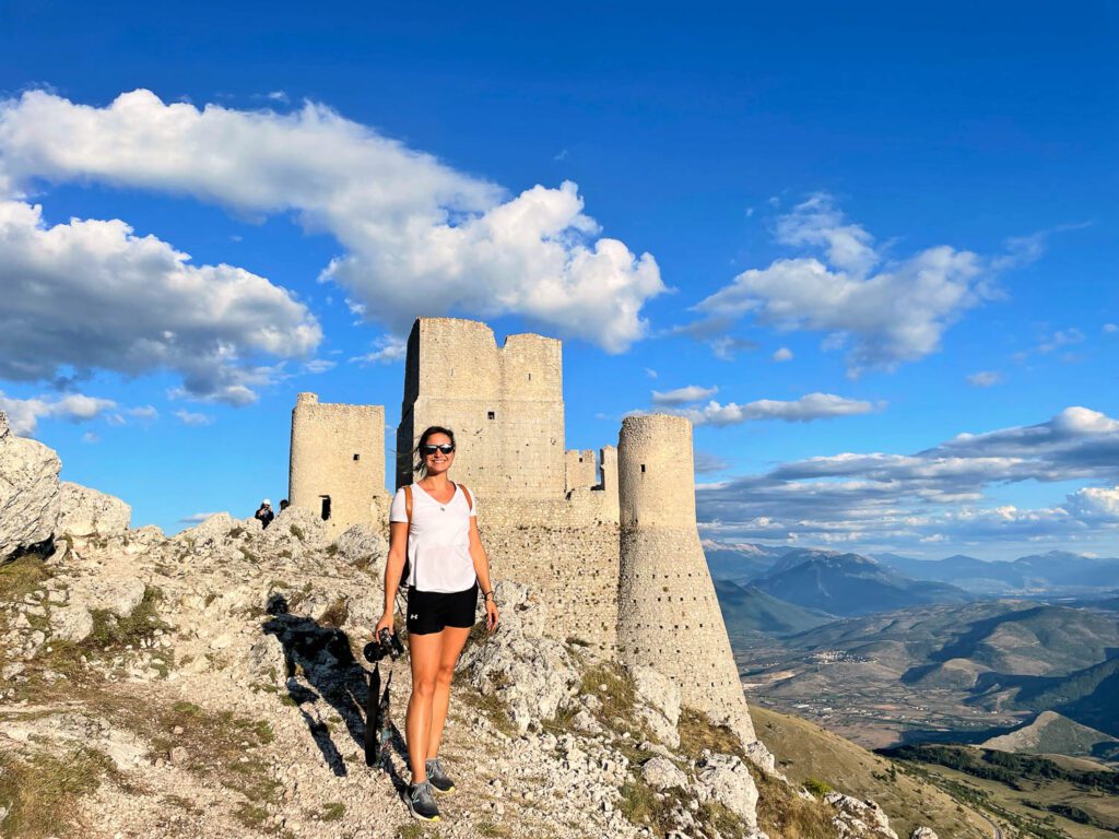 travel photographer Raffaella De Amicis wanderstruck ella in front of Rocca Calascio castle in Abruzzo Italy